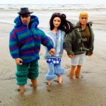 The Happy Somethings as dolls on a beach